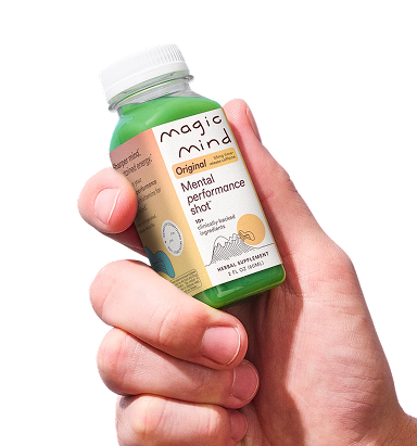 Close-up of a hand gripping a Magic Mind Original mental performance shot bottle.