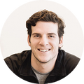 A circular portrait of James Beshara, founder of Magic Mind, smiling in a black jacket against a clean white background.