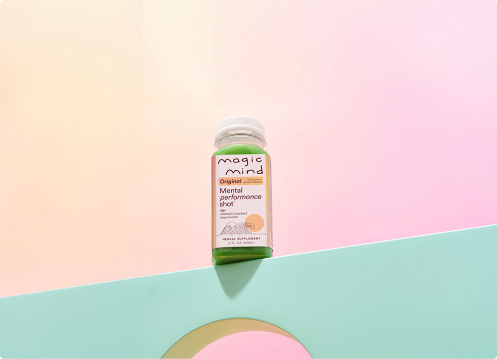 Magic Mind Original Mental Performance Shot bottle on a pastel pink and mint background.