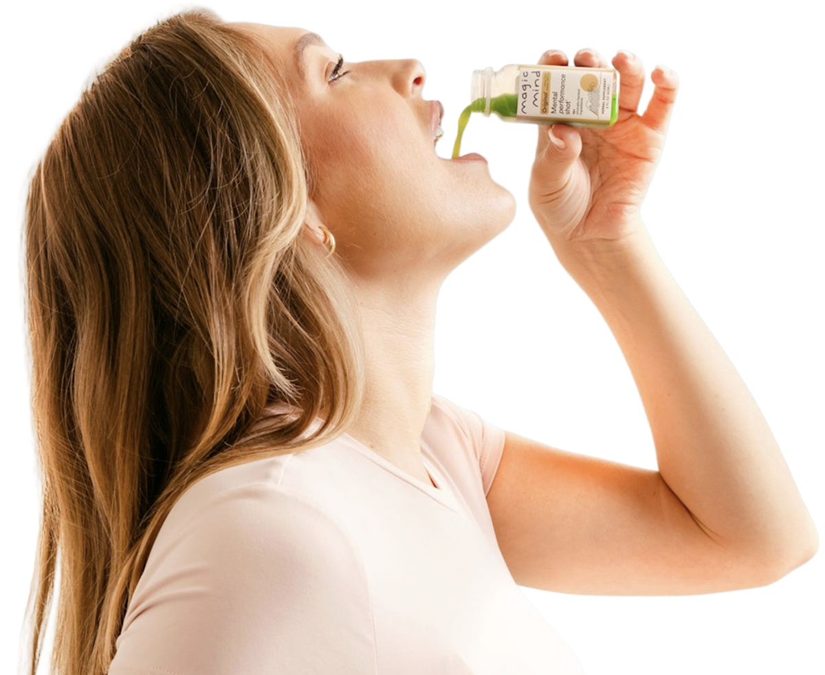 Woman drinking a Magic Mind Mental Performance Shot from the bottle.